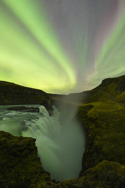 the Northern Lights over iconic Gullfoss waterfall during an autumn night, Iceland, Europe