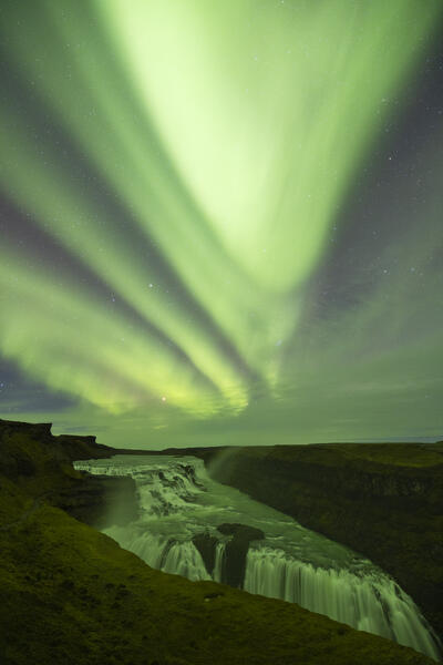the Northern Lights over iconic Gullfoss waterfall during an autumn night, Iceland, Europe