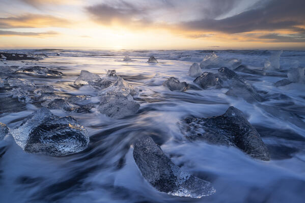 the ice blocks of the famous Black Sand Beach, taken during an autumn sunrise, Jokusarloon, Iceland, Europe