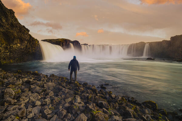 one guy admire the sunset at Godafoss waterfall during a summer day, Iceland, Europe (MR)