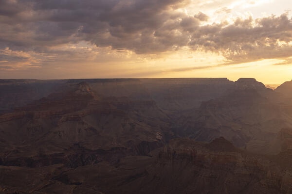 a golden light envelope the Grand Canyon during a summer sunrise, Tusayan, Arizona, United States of America