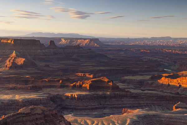 the sunlight envelope the Canyonlands valley during a summer sunrise, Utah, United States of America