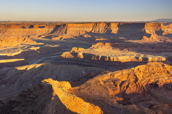 the sunlight envelope the Canyonlands valley during a summer sunset, Utah, United States of America