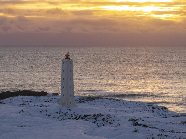 aerial view taken by drone of Malarrif Lighthouse during a cold winter sunset, Snaefelsness peninsula, Iceland, Europe