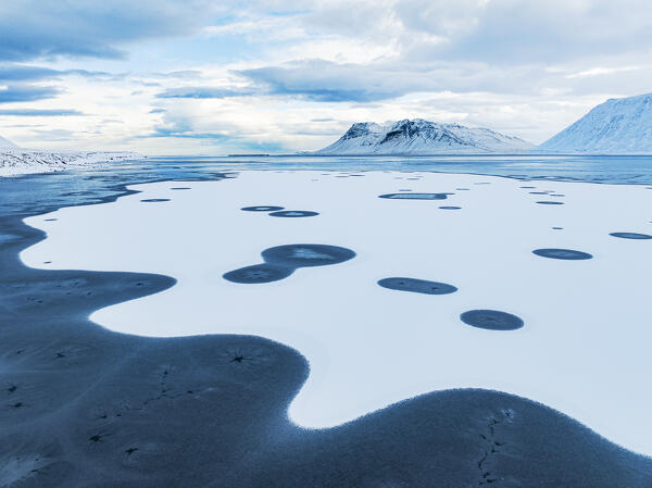 aerial view from a drone of particular ice formations formed in the fjord during a cold winter day, Grundafjordur, Iceland, Europe