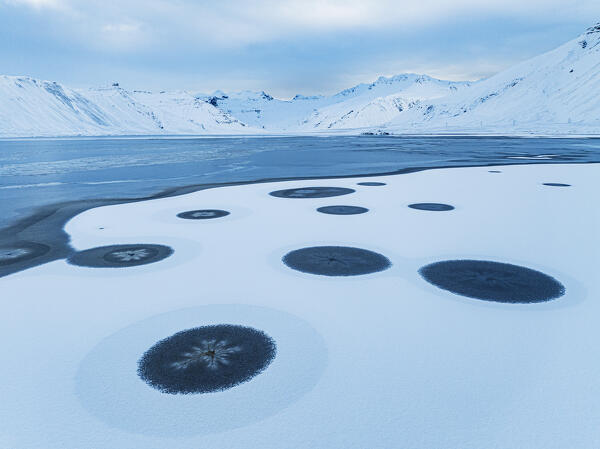 aerial view from a drone of particular ice formations formed in the fjord during a cold winter day, Grundafjordur, Iceland, Europe