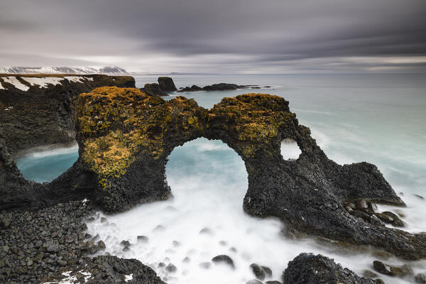 the famous basalt rock arch of Gaklettur, near the village of Arnastapi, taken with a long exposure during a cold winter day, Arnastapi, Iceland, Europe