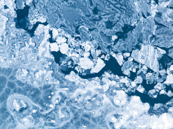 vertical aerial view from a drone of particular ice formations formed in the fjord during a cold winter day, Grundafjordur, Iceland, Europe