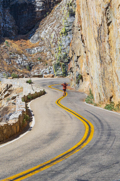 a woman admire the famous Kings Canyon mountain road on a summer day, California, United States of America (MR)