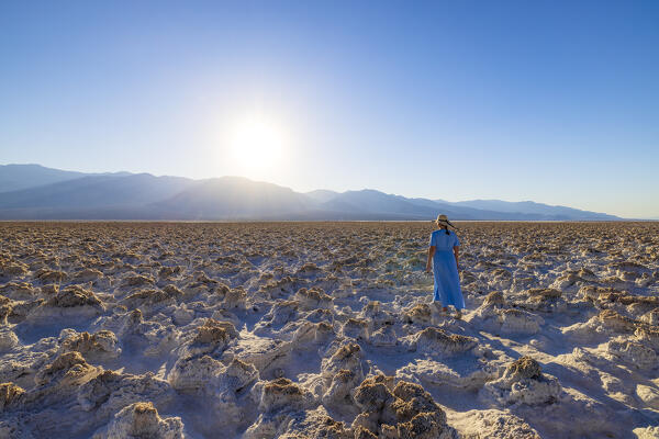 a woman admire the beautiful view at Devil's Golf Course during a summer day, Death Valley National Park, California, United States of America