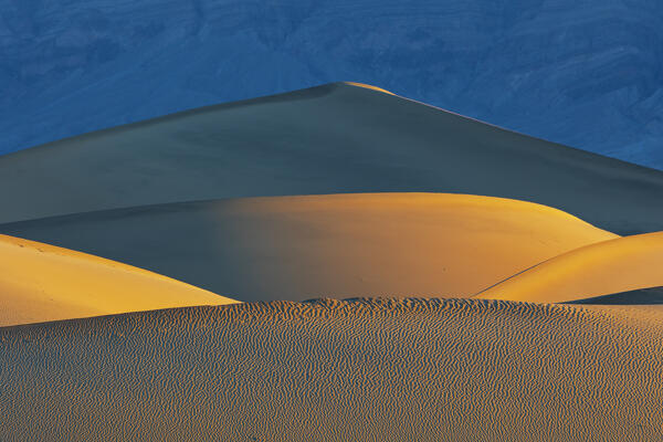 the beautiful sand dunes illuminated by the warm light of dawn, Mesquite Flat Sand Dunes, Death Valley, California, United States of America