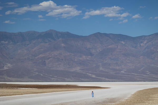 a woman admire the beautiful panorama at Badwater Basin during a summer sunny day, Death Valley National Park, California, United States of America