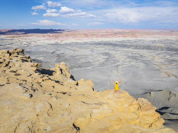 a girl admire the beautiful view of Overlook Moon during a sunny summer day, Hanksville, Utah, United States of America