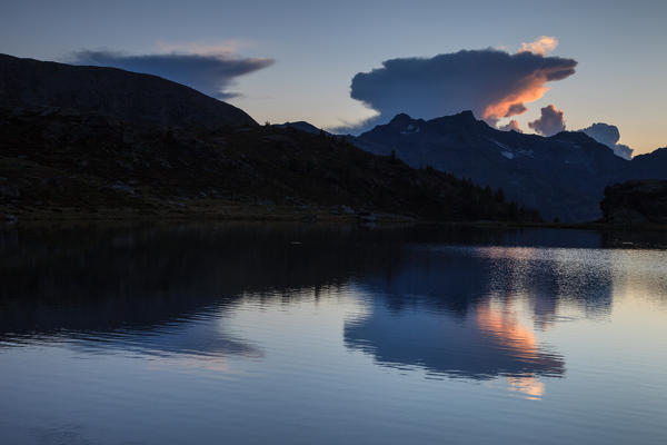 Reflection clouds on the Angeloga lake, Spluga valley, Lombardy, Italy