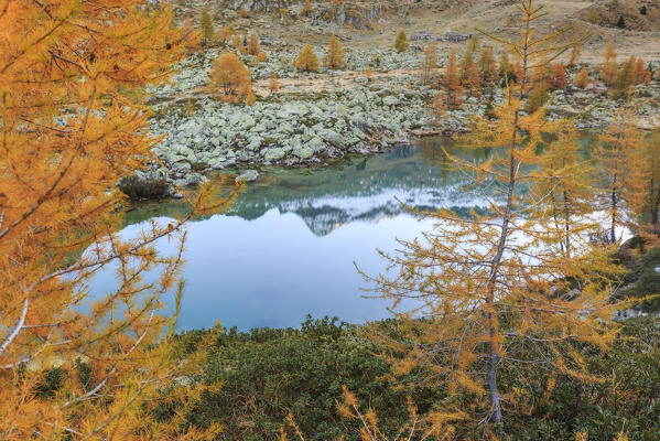 Lombardy, Italy, autumn in Painale valley. Scalino peak reflected in Painale lake
