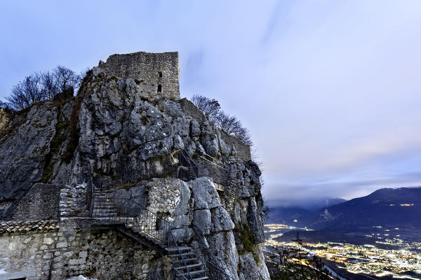 The medieval ruins of Corno Castle perched on the rocks of Mount Biaena. Isera, Trento province, Trentino Alto-Adige, Italy, Europe.