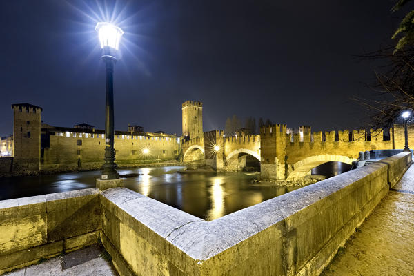 Streetlight illuminates the night at Castelvecchio. Verona, Veneto, Italy, Europe.