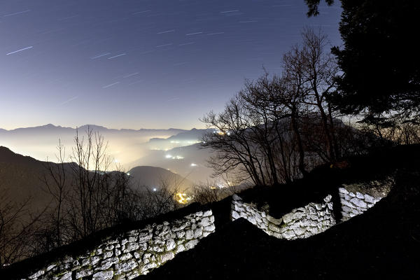 Night at Mount Creino: Austro-Hungarian trenches of the Great War. In the background the Adige Valley. Gresta Valley, Trento province, Trentino Alto-Adige, Italy, Europe.