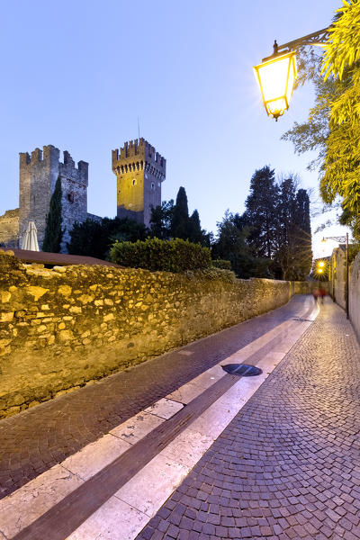 Pathway in the ancient town of Lazise and the Scaligero castle. Verona province, Veneto, Italy, Europe.