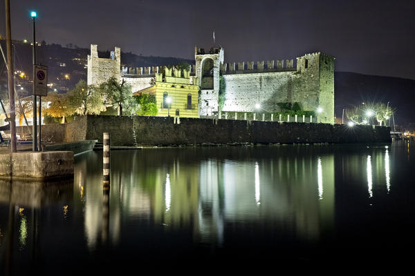 The Scaligero castle of Torri del Benaco is reflected in Lake Garda. Verona province, Veneto, Italy, Europe.