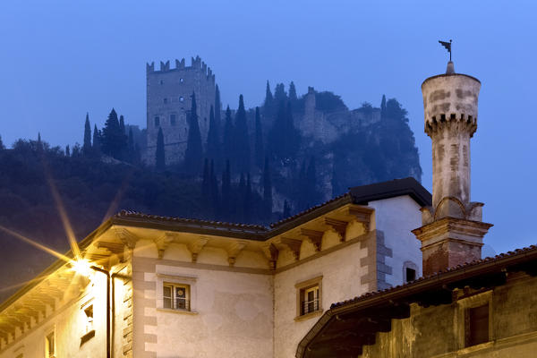 The chimney of the ancient Marchetti Palace and the medieval castle of Arco. Trento province, Trentino Alto-Adige, Italy, Europe.