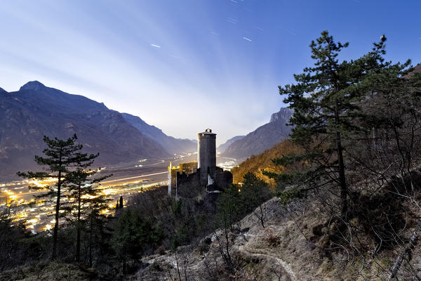 The castle of Avio and the Adige Valley in the moonlight. Trento province, Trentino Alto-Adige, Italy, Europe.