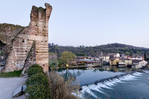 The ancient walls of the Visconteo bridge and the hamlet of Borghetto sul Mincio. Verona province, Veneto, Italy, Europe.