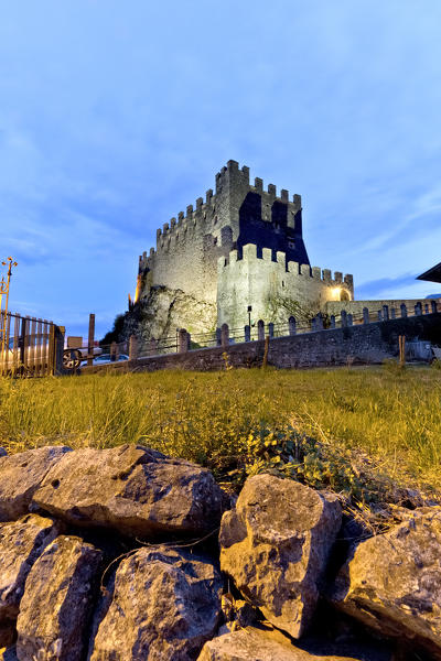 Evening falls on the imposing castle of Tenno. Trento province, Trentino Alto-Adige, Italy, Europe.