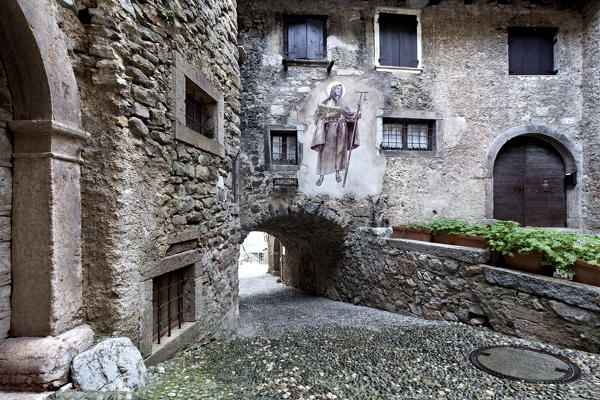 Fresco on the stone houses of the medieval village of Canale di Tenno. Trento province, Trentino Alto-Adige, Italy, Europe.