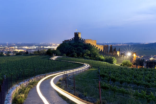 The Scaligero castle and the road among the Soave vineyards. Soave, Verona province, Veneto, Italy, Europe. 