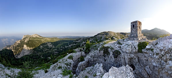 Austrian memorial stone on the top of Mount Ortigara and the battlefield of the Great War: on the left Cima della Caldiera, at the center of the Agnellizza Valley (or 