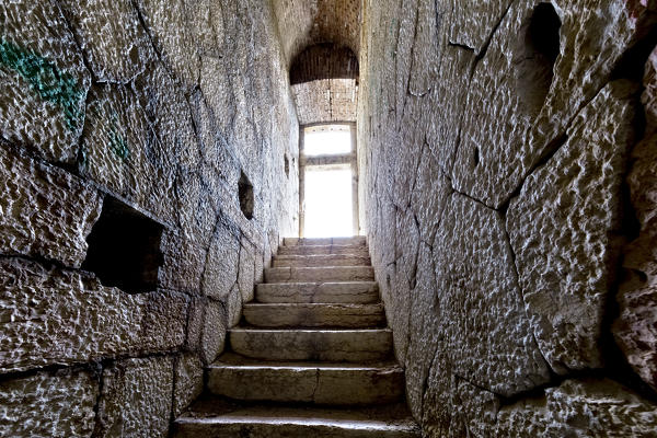 Narrow staircase between the mighty walls of Fort Mollinary. Monte, Verona province, Veneto, Italy, Europe.