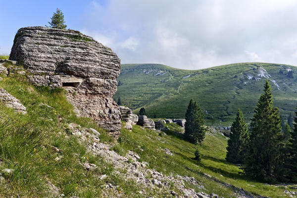 Mount Castelgomberto: during the Great War a machine-gun emplacement was dug in this rock. Right: mount Fior with zigzag trenches. Asiago Plateau, Vicenza province, Veneto, Italy, Europe.