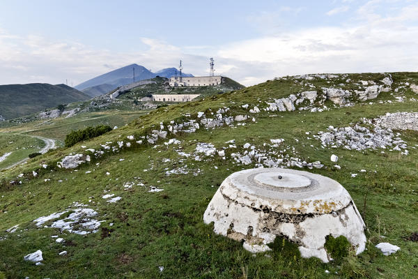 Basement of an anti-aircraft emplacement of the Great War and, in the background, Fort Naole. Naole Ridge, Mount Baldo, Verona province, Veneto, Italy, Europe.