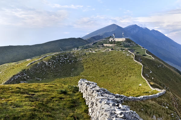 Ancient walls to fence the pastures on the Naole ridge. On the top of the mountain: the Italian fort of Naole. Mount Baldo, Verona province, Veneto, Italy, Europe.