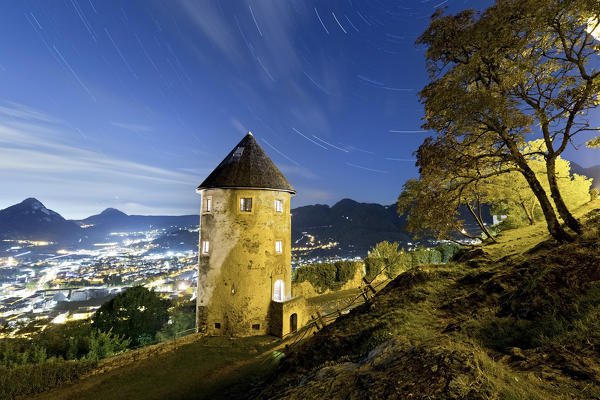 Star Trail above the medieval castle of Pergine. Trento province, Trentino Alto-Adige, Italy, Europe.