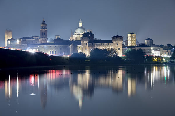 Mantova is reflected on the middle lake of the Mincio river. The city is one of the main centers of the Italian and European Renaissance, it has been included in the list of UNESCO World Heritage Sites. Lombardy, Italy, Europe.