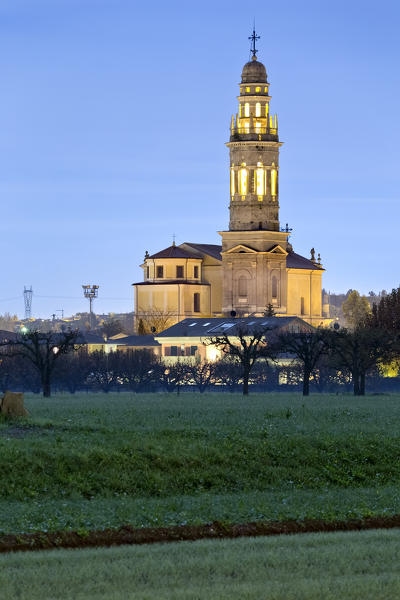 Full moon night at the Cathedral of San Lorenzo Martire in Pescantina. Verona province, Veneto, Italy, Europe.