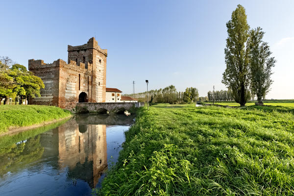 The Scaliger tower of Isola della Scala and the river Tartaro. Verona province, Veneto, Italy, Europe.