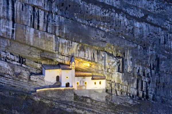 The hermitage of San Colombano was built in the Middle Ages in a niche of the rocky wall. Trambileno, Trento province, Trentino Alto-Adige, Italy, Europe.