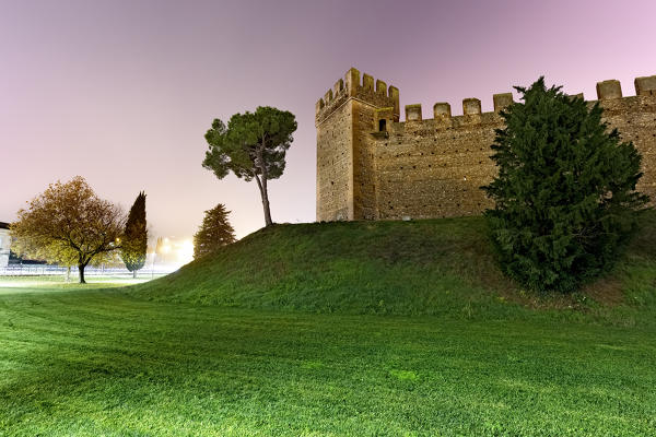 The walls of the Scaliger castle on a hazy night. Verona province, Veneto, Italy, Europe.