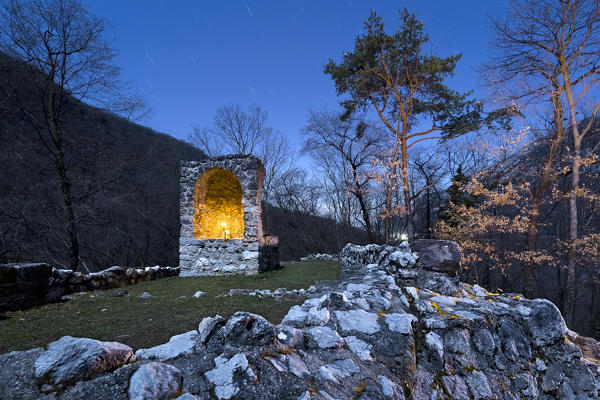 The ruins of the Romanesque church on the top of the Sant'Andrea Island in the Loppio lake. They are part of a vast didactic-archaeological itinerary. Mori, Trento province, Trentino Alto-Adige, Italy, Europe. 