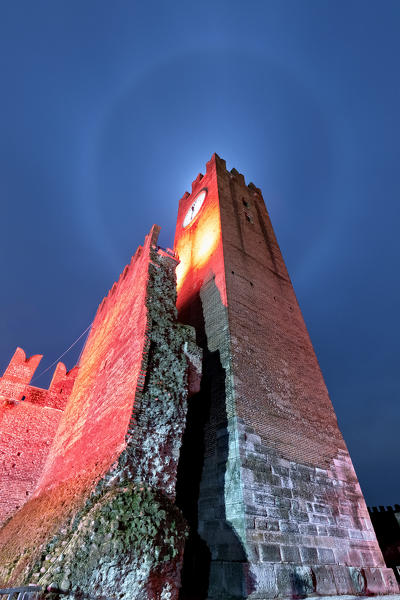 Lunar halo over the keep of the Scaliger castle of Villafranca di Verona. Verona province, Veneto, Europe, Italy.