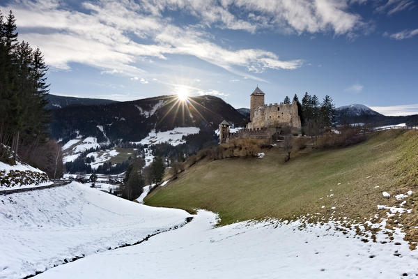 Reinegg castle and Sarentino valley at sunset. Bolzano province, Trentino Alto-Adige, Italy, Europe. 