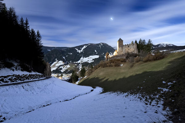 Moonlight over Reinegg castle and Sarentino valley. Bolzano province, Trentino Alto-Adige, Italy, Europe. 