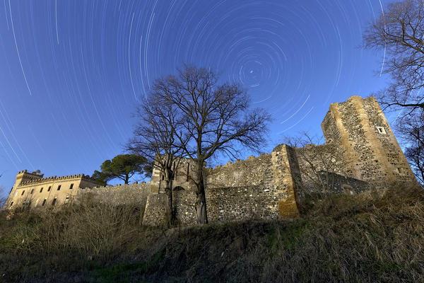 Star trails above the Maltraverso castle in Montebello Vicentino. Vicenza province, Veneto, Italy, Europe.