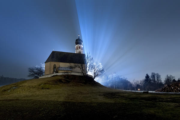 Hazy night at the San Costantino church. Fiè allo Sciliar, Bolzano province, Trentino Alto-Adige, Italy, Europe. 