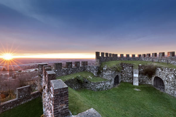 The sun sets on the crenellated walls of the Rocca di Lonato. Lonato del Garda, Brescia province, Lombardy, Italy, Europe.