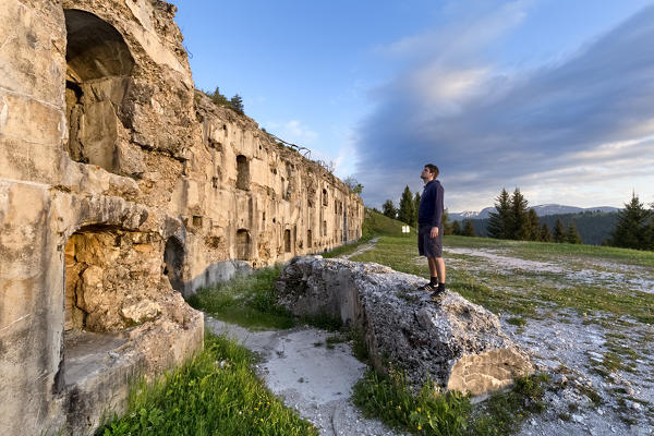 Man stands in front of the Fort Sommo Alto. Folgaria, Trento province, Trentino Alto-Adige, Italy, Europe.