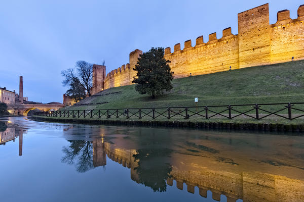 Dusk on the medieval walls of Cittadella, reflected in the water of the moat. Padova province, Veneto, Italy, Europe.